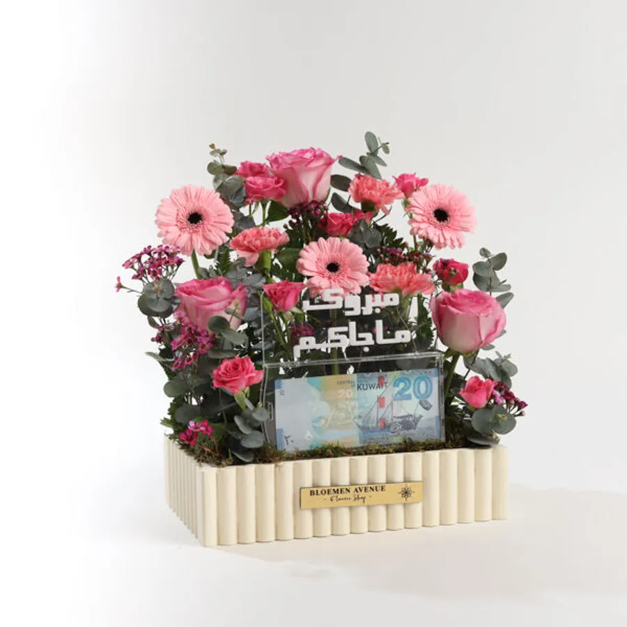 M41 A wooden box of pink flowers and includes an empty money box with the words " Mabrouk Ma Jakom "