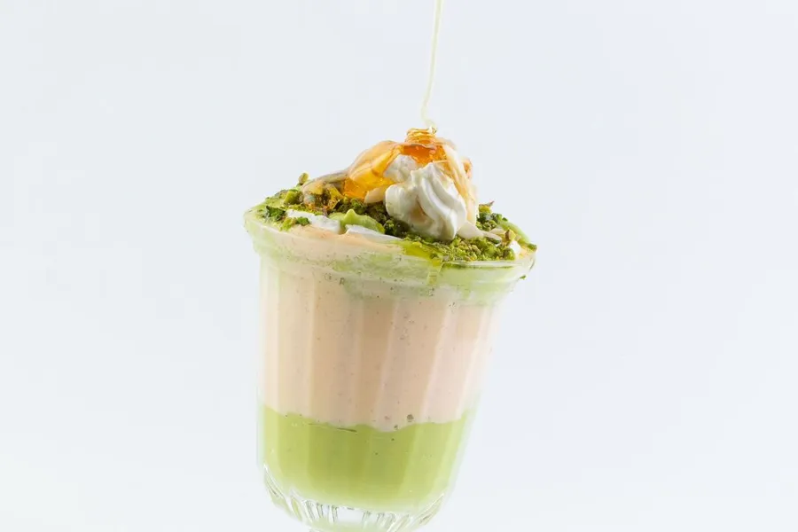 Fresh avocado with cream, nuts and honey