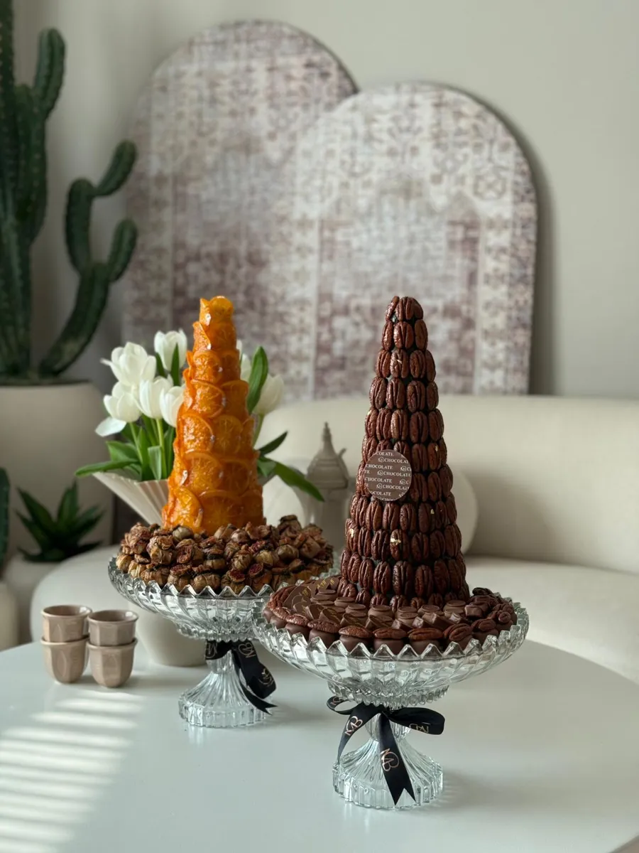 Pecan tower with orange tower, citrus fruits, and a musakhan