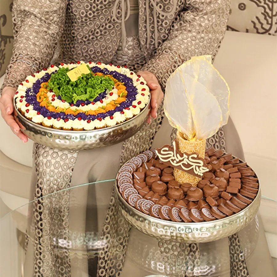 A tray of chocolates with a mix of pastries, silver color eid (decoration)
