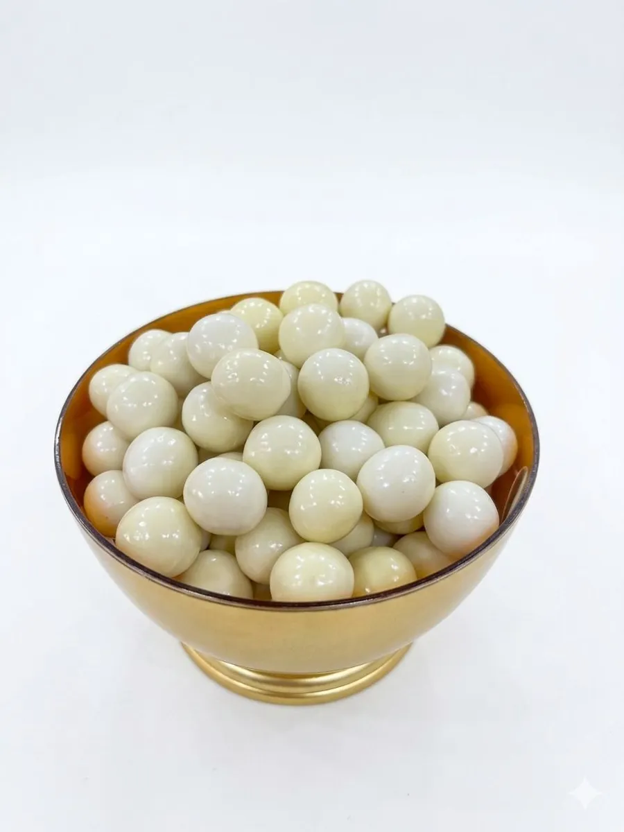 Coconut dragee coated in white chocolate