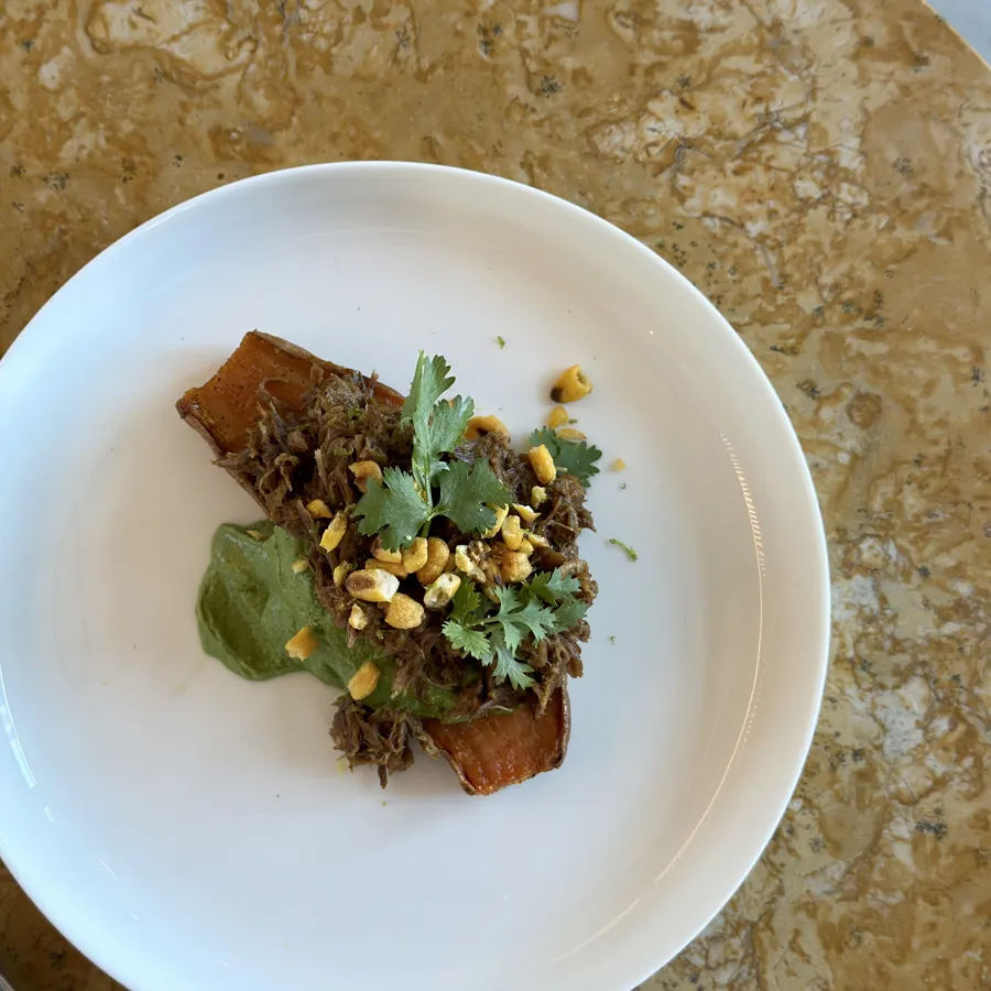 tamarind braised lamb on roasted sweet potato, chutney and crispy corn